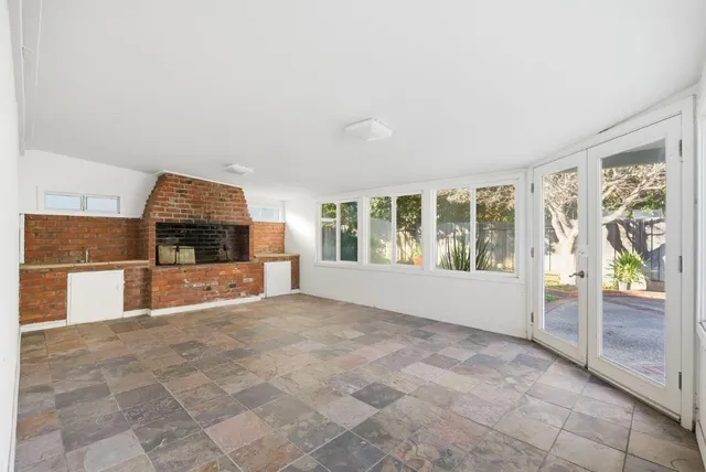 an aerial view of a house with swimming pool and wooden fence