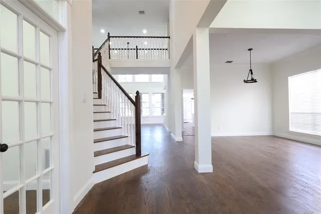 a view of entryway and hall with wooden floor