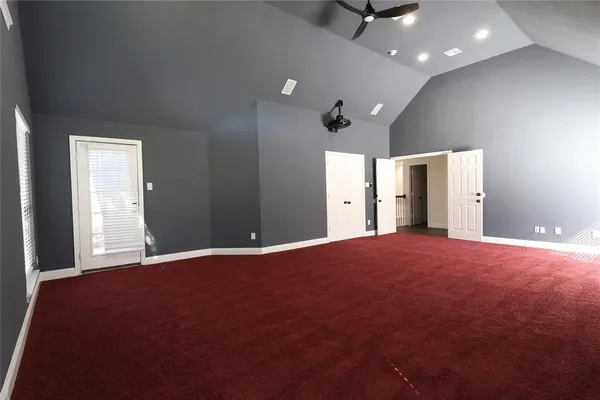 a view of an empty room with a kitchen