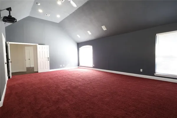 an empty room with windows and entrance