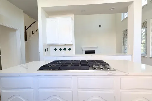 a bathroom with a granite countertop sink and a window
