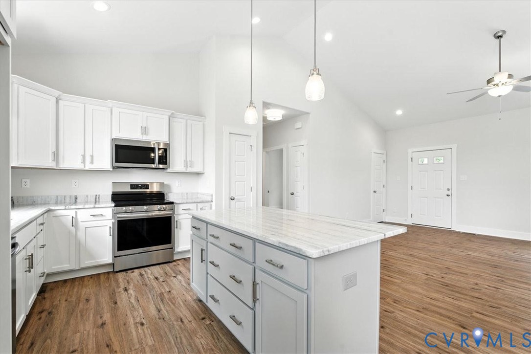 3898 Horseshoe Road Appomattox, VA 24522 - Photo 13 of 32 a kitchen with a stove a sink and a microwave
