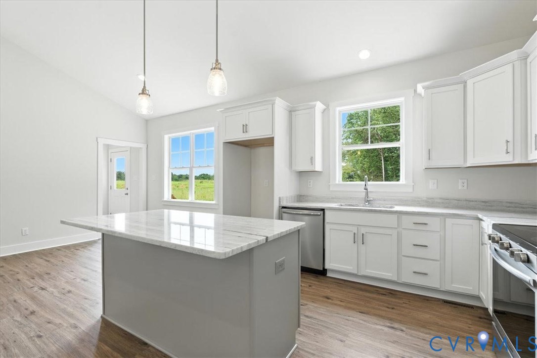 3898 Horseshoe Road Appomattox, VA 24522 - Photo 14 of 32 a large kitchen with kitchen island a large counter top space windows and a sink