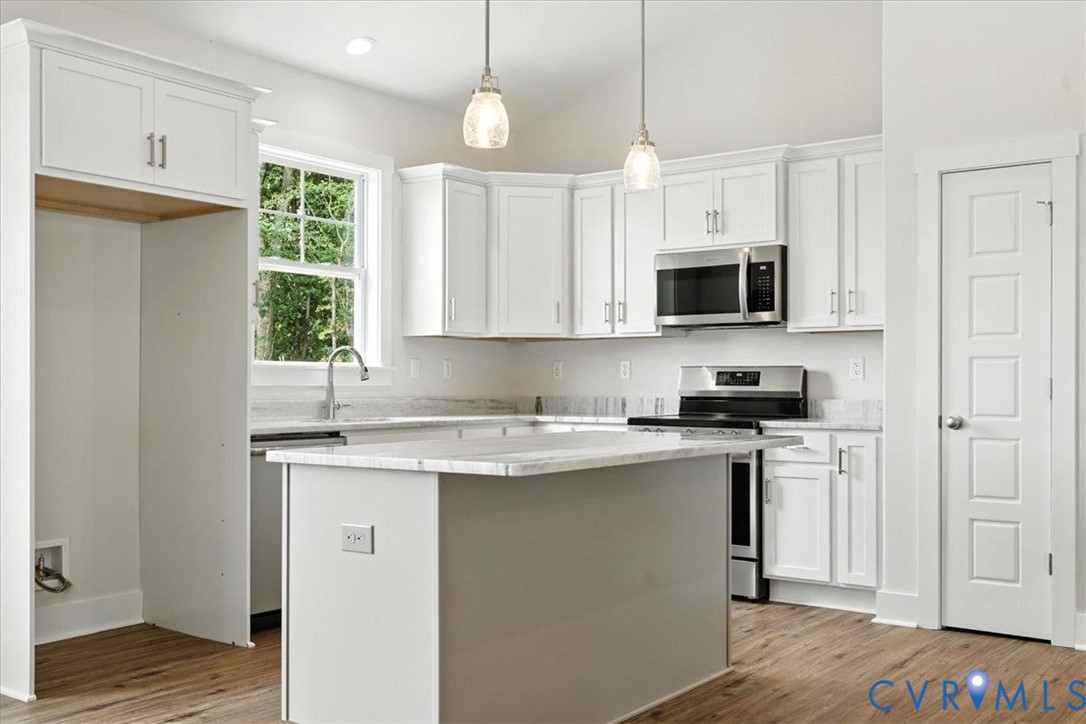 3898 Horseshoe Road Appomattox, VA 24522 - Photo 16 of 32 a kitchen with stainless steel appliances granite countertop a stove a sink and a microwave