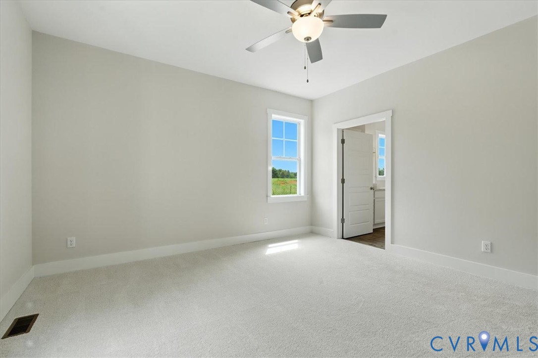 3898 Horseshoe Road Appomattox, VA 24522 - Photo 21 of 32 an empty room with a chandelier fan and windows