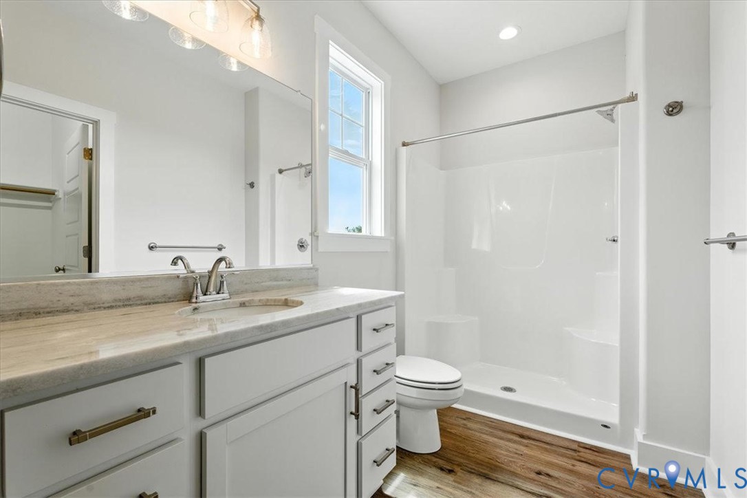 3898 Horseshoe Road Appomattox, VA 24522 - Photo 23 of 32 a bathroom with a granite countertop sink a toilet and shower