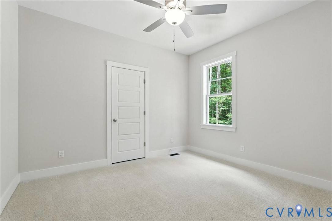 3898 Horseshoe Road Appomattox, VA 24522 - Photo 25 of 32 an empty room with a ceiling fan and windows