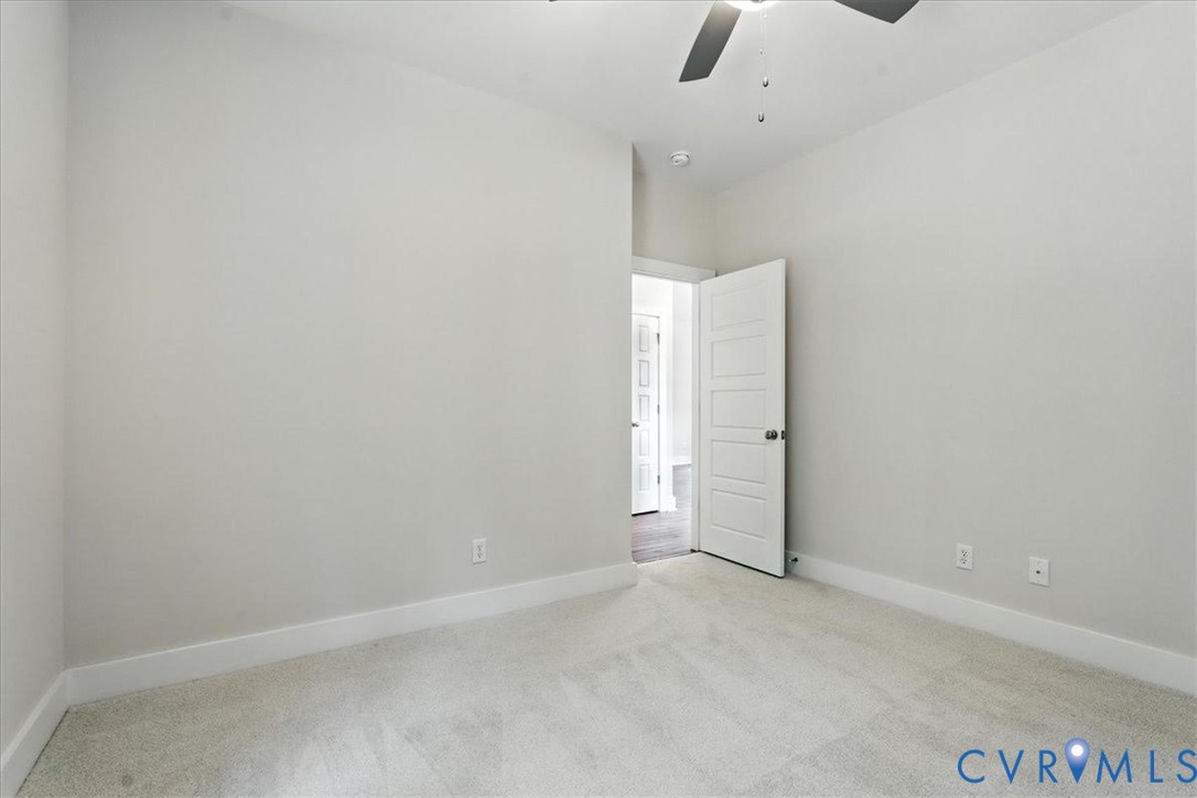 3898 Horseshoe Road Appomattox, VA 24522 - Photo 26 of 32 an empty room with an entryway and chandelier fan
