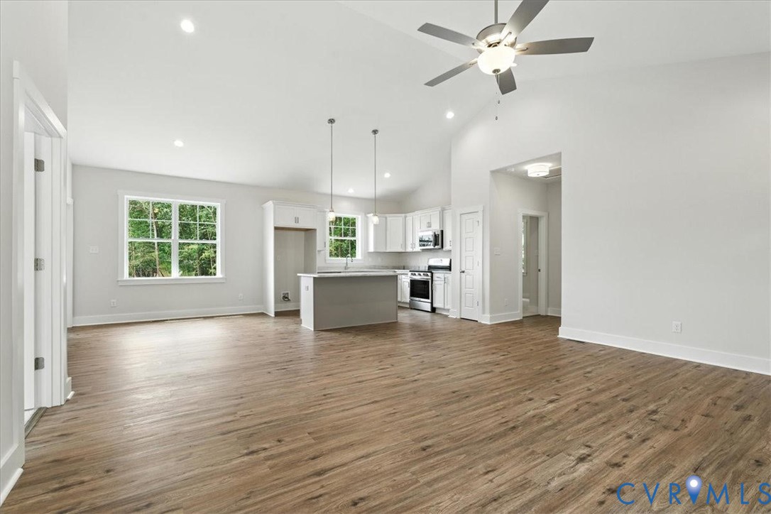 3898 Horseshoe Road Appomattox, VA 24522 - Photo 7 of 32 a view of an empty room with window and wooden floor
