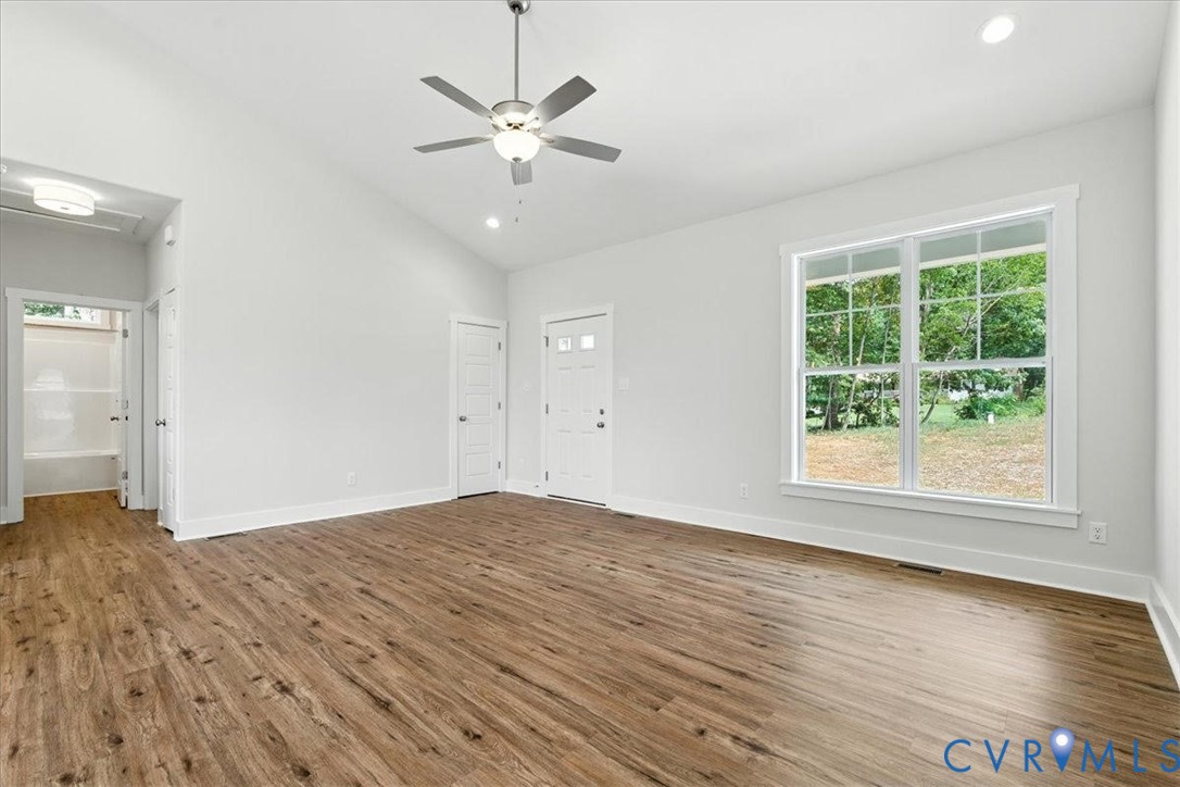 3898 Horseshoe Road Appomattox, VA 24522 - Photo 9 of 32 an empty room with wooden floor and windows