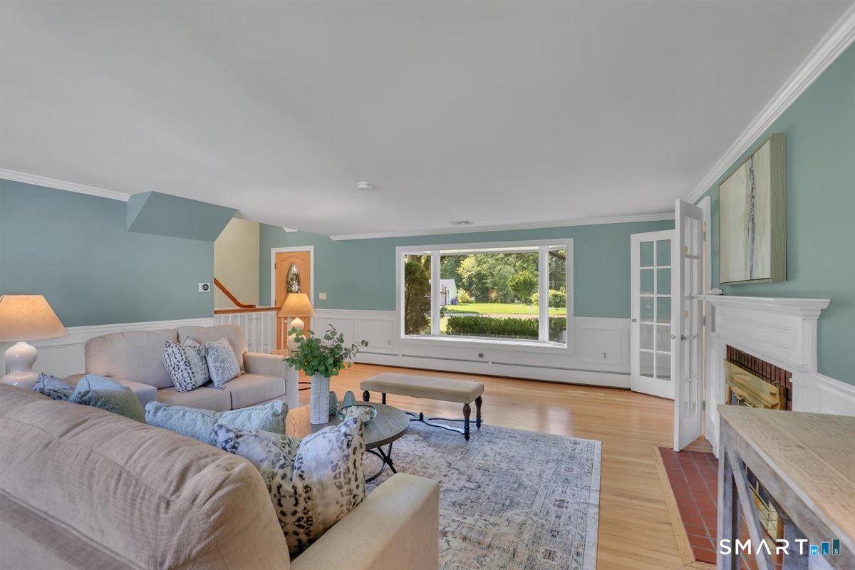 361 Miles Road Orange, CT 06477 - Photo 4 of 40 The living room is just off the front entry, with French doors shown at right opening to the kitchen and dining area. A single step down creates a subtle separation while maintaining an easy, open flow between spaces.