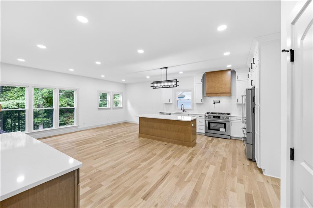 1749 Patriots Way Northwest Kennesaw, GA 30152 - Photo 17 of 54 a large white kitchen with wooden floor and a sink