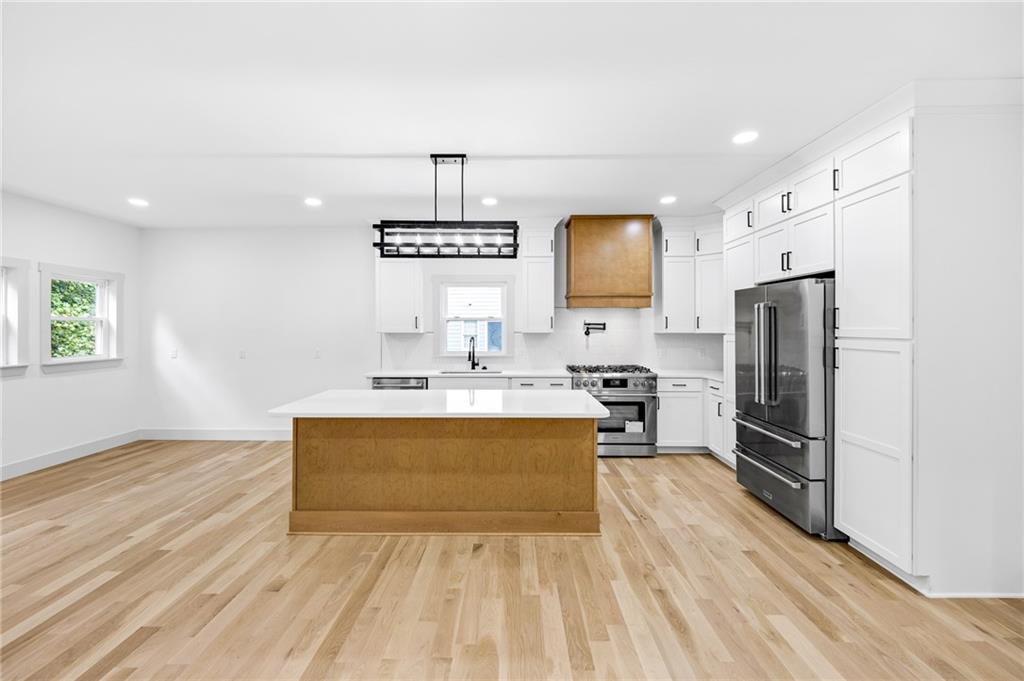 1749 Patriots Way Northwest Kennesaw, GA 30152 - Photo 19 of 54 a kitchen with stainless steel appliances a sink stove and refrigerator