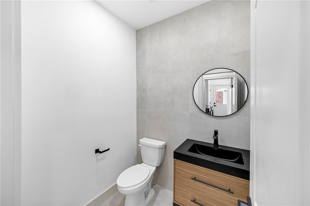 1749 Patriots Way Northwest Kennesaw, GA 30152 - Photo 22 of 54 a bathroom with a toilet and a mirror