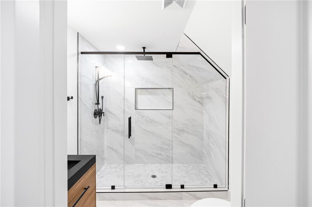 1749 Patriots Way Northwest Kennesaw, GA 30152 - Photo 36 of 54 a bathroom with a glass shower door