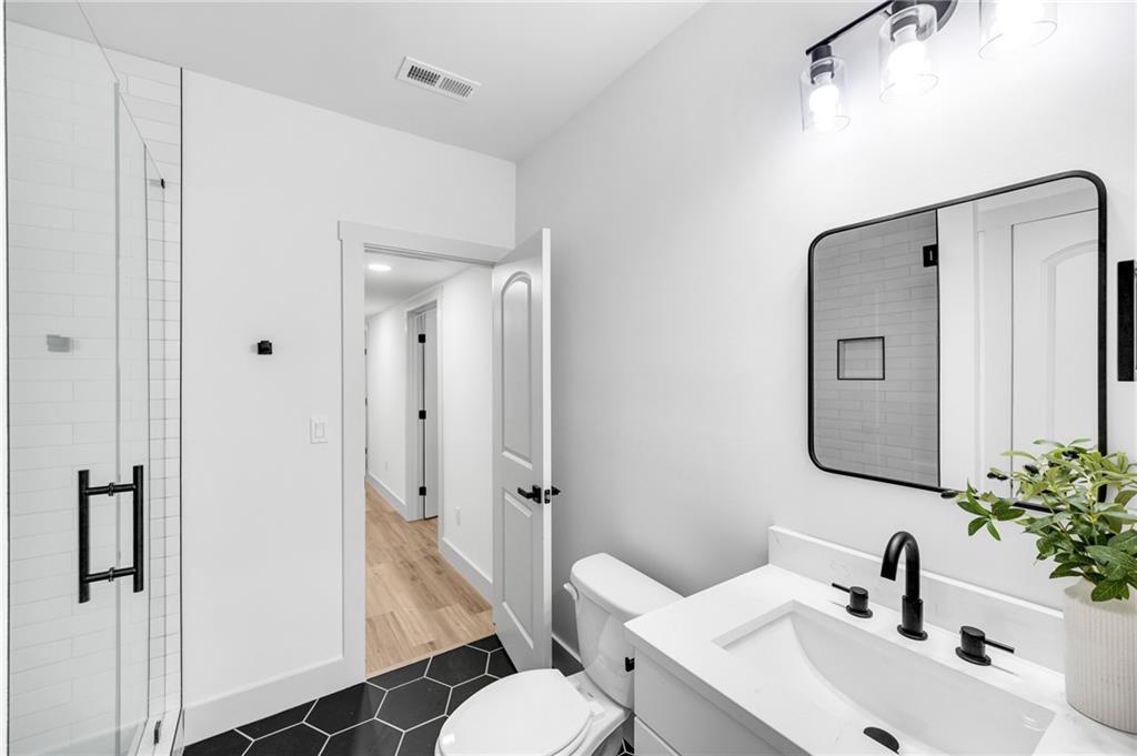 1749 Patriots Way Northwest Kennesaw, GA 30152 - Photo 43 of 54 a bathroom with a toilet sink and shower