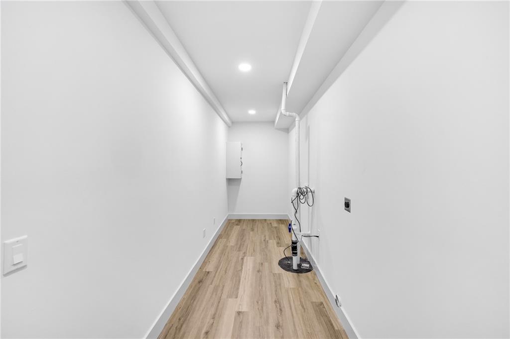 1749 Patriots Way Northwest Kennesaw, GA 30152 - Photo 52 of 54 a view of a hallway with wooden floor and a bathroom