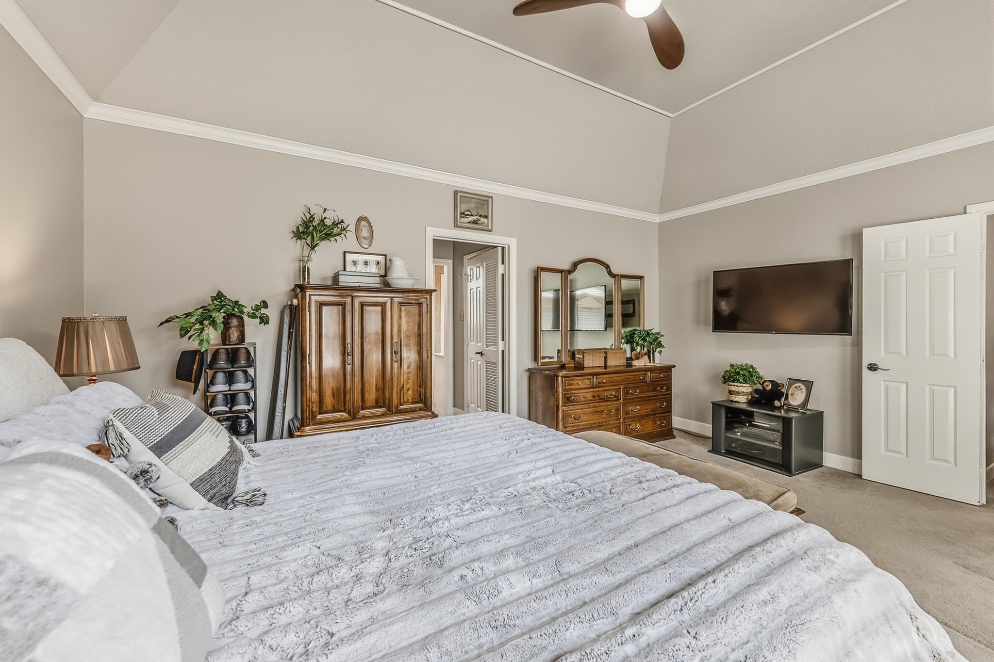 6047 Spring Creek Lane Spring, TX 77379 - Photo 10 of 50 Positioned just off the ensuite bath, the primary suite was designed with comfort and privacy in mind. Thoughtful proportions, layered textures, and a tucked away sitting area give the room a relaxed, residential elegance.