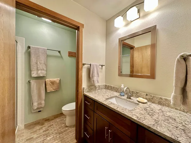 a white toilet sitting next to a bath tub