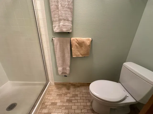 a bathroom with a glass shower door