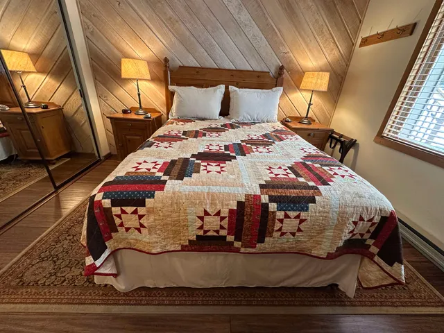 a bed sitting in a bedroom next to a window