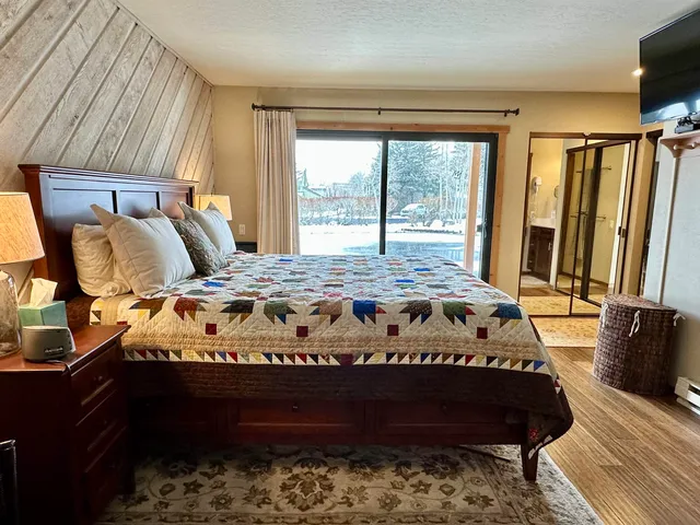 a bedroom with a bed and flat screen tv