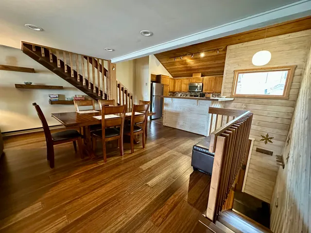 a view of a dining room with furniture and wooden floor