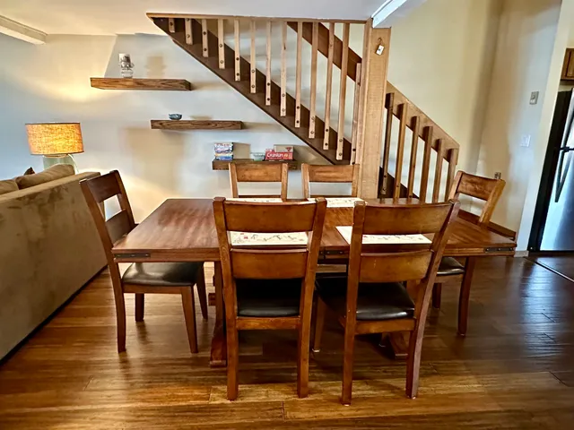a dining room with furniture window and wooden floor