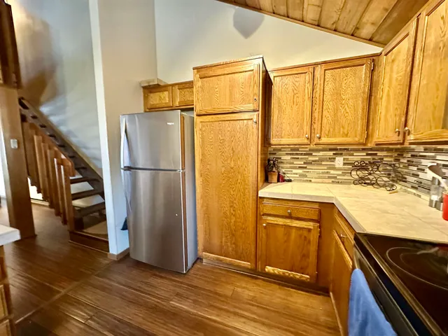 a kitchen with a refrigerator sink and cabinets