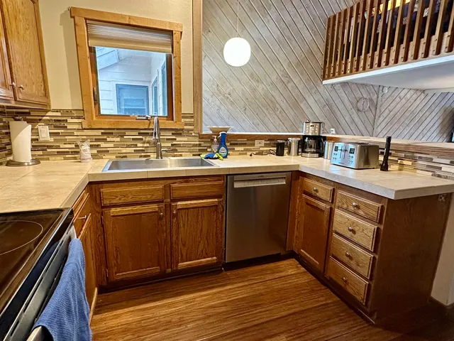 a kitchen with a refrigerator and a stove