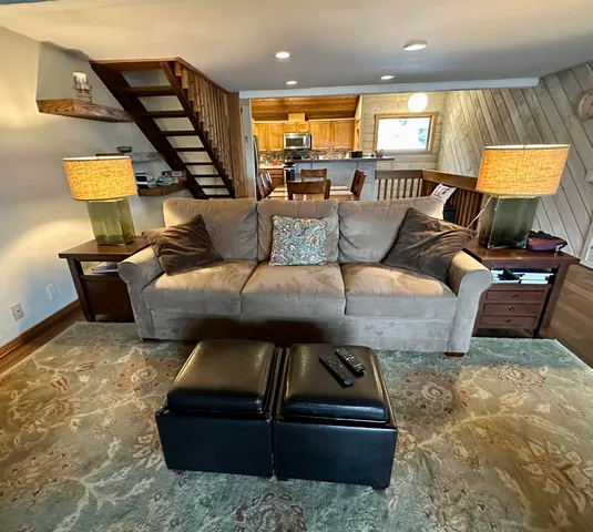 a living room with furniture a fireplace and a large window