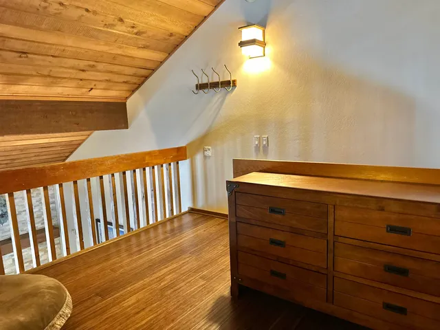 a view of a balcony with wooden chairs