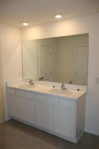 a bathroom with double sink and mirror