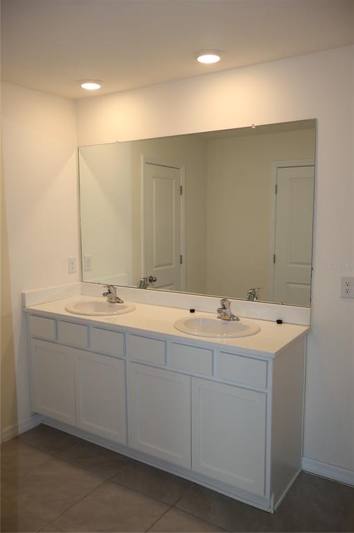 8627 Southwest 45th Court Ocala, FL 34476 - Photo 26 of 39 a bathroom with double sink and mirror