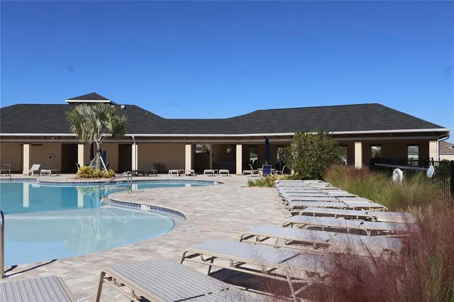 a view of house with outdoor space and swimming pool