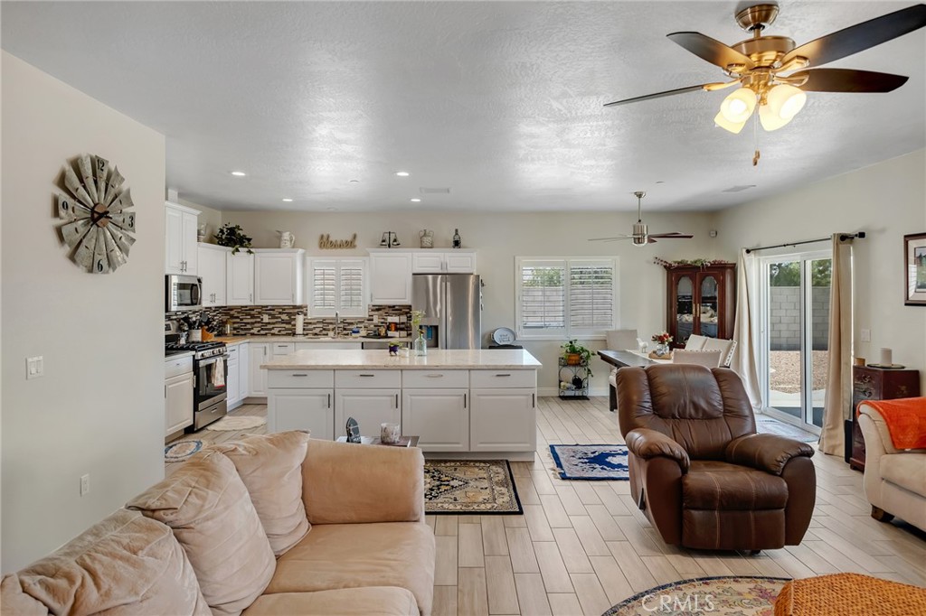 13178 Setancket Road Apple Valley, CA 92308 - Photo 6 of 24 a living room with furniture and kitchen view