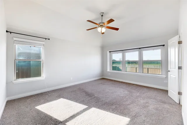 a view of a livingroom with a ceiling fan and window