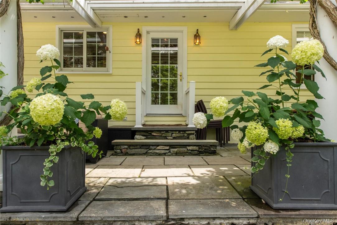 247 North Mabbettsville Road Millbrook, NY 12545 - Photo 22 of 25 a white house with a flower garden