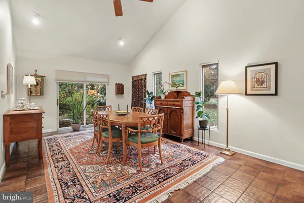 a dining room with furniture a rug a rug and a chandelier