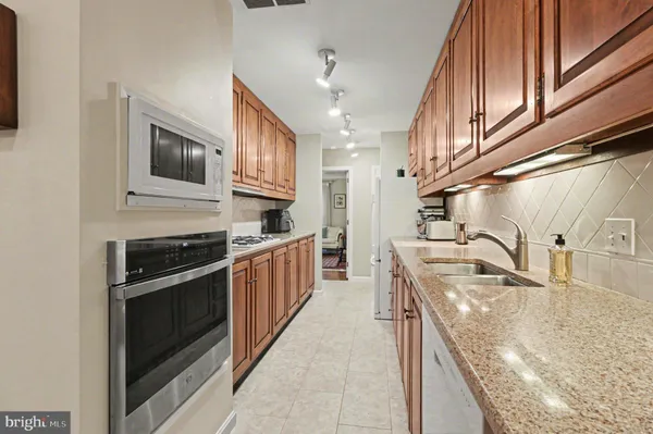 a kitchen with stainless steel appliances granite countertop a sink and stove