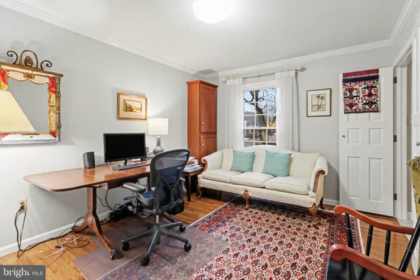 a living room with furniture a rug and a window