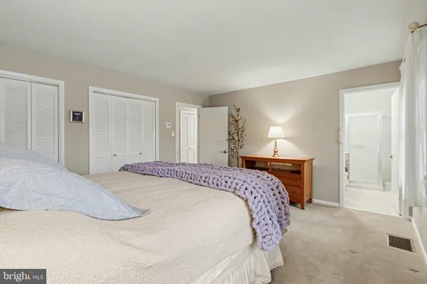 a bedroom with a bed and lamp