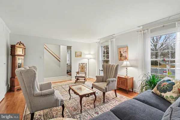 a living room with furniture wooden floor and a window