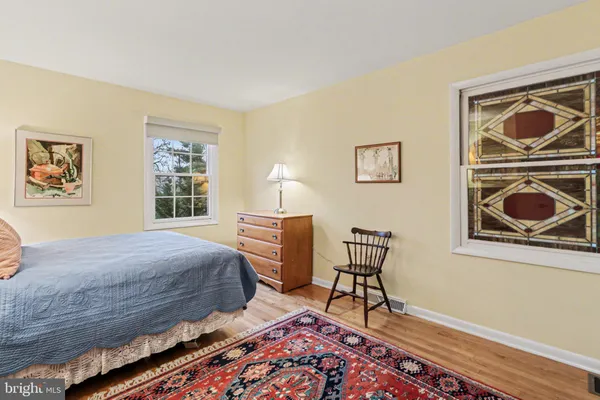 a bedroom with a large bed and a chandelier