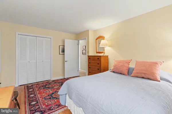 a bedroom with a bed and a dresser