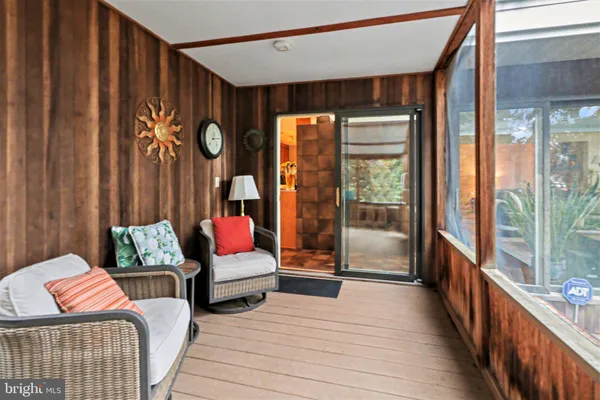 a balcony with furniture and wooden floor