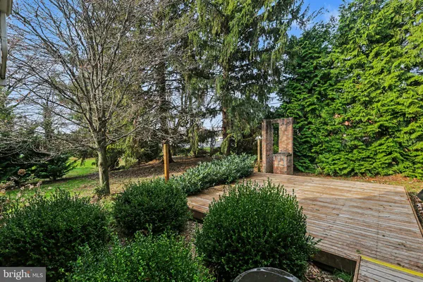 a front view of a house with garden and plants