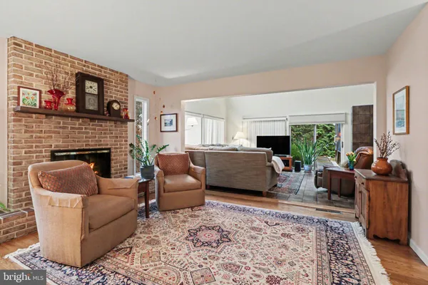 a living room with furniture fireplace and window