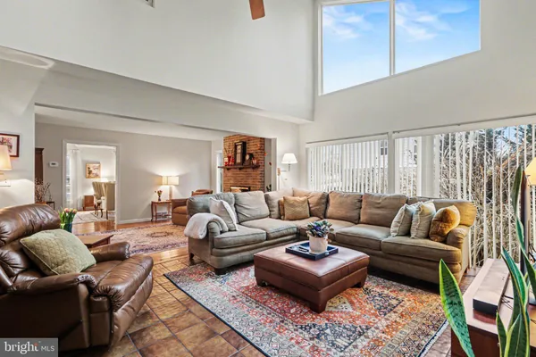 a living room with furniture a rug and a window