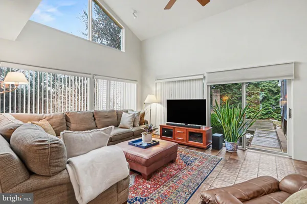 a living room with furniture tv and a window